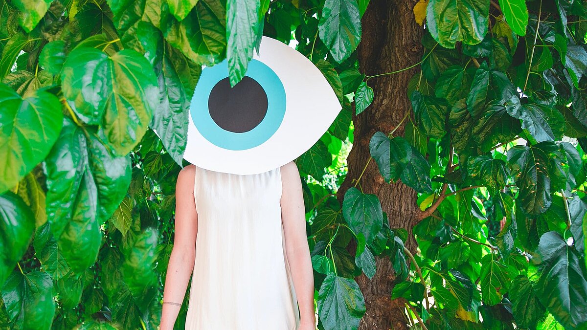 Woman in the forest with a big eye on the environment