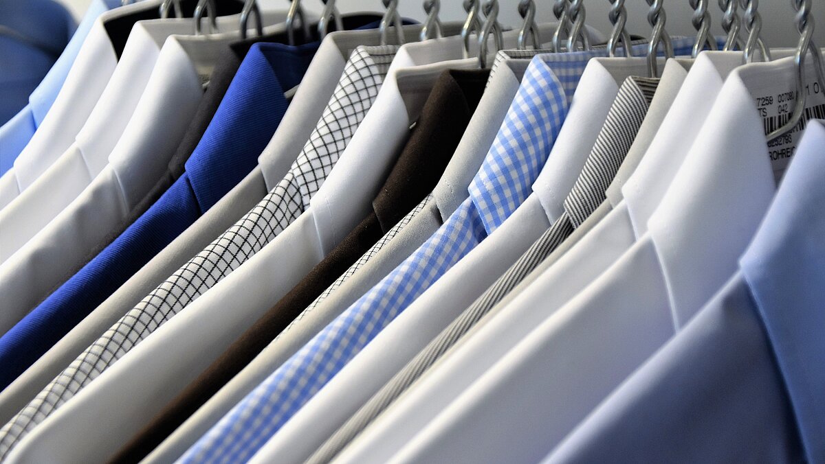 Button down shirts on handers in different shades of blue