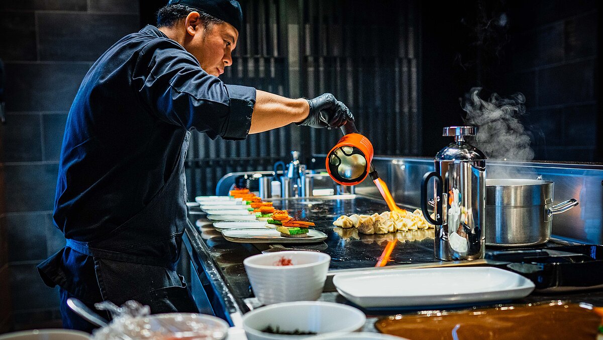 man cooking in uniform